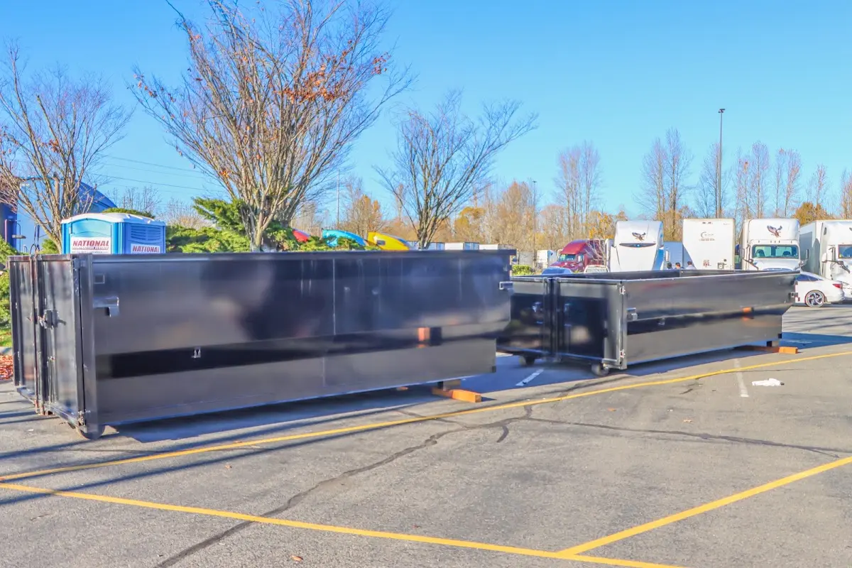 Professional dumpster rental service with roll-off container on residential driveway in Chapel Hill